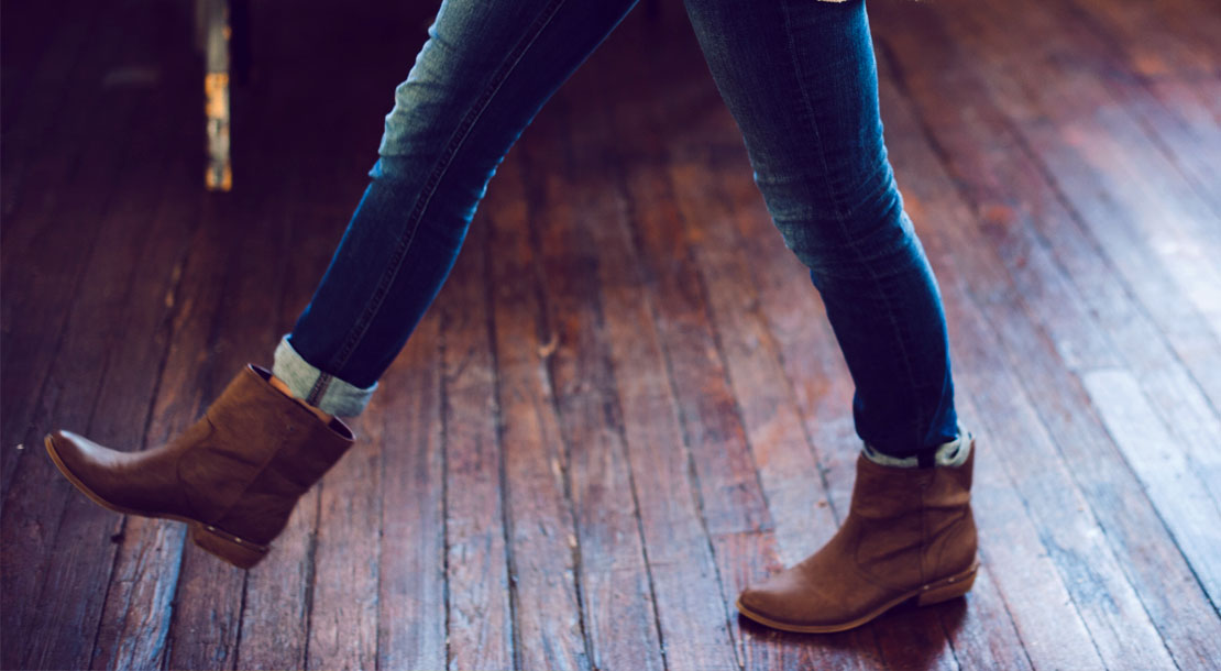 WomanWalkingAcrossWoodenFloor