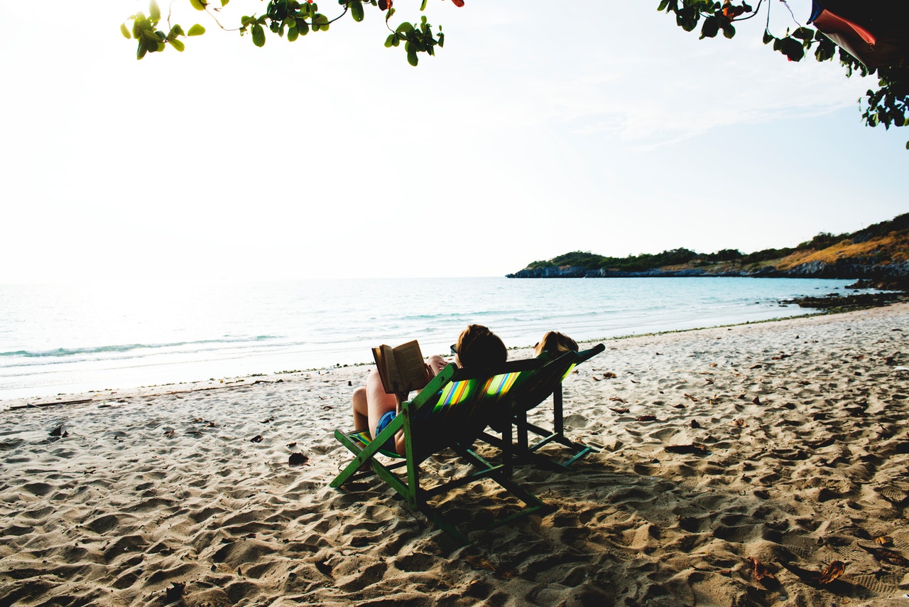 Image of someone relaxed and reading on a beach - is your business ready for your freedom?